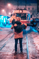 Young adult couple on the snow-covered tram line