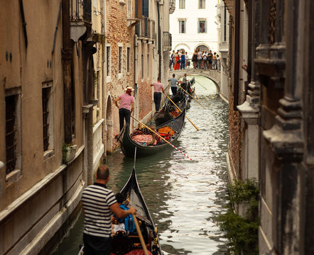 Italy, Venice, July 12, 2019, Gandol series in the narrow canal of Venice.