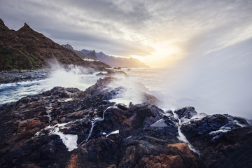 view of wild Benijo beach with big waves and black sand on the north coast of the Tenerife island, Spain - long exposure image