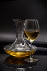 Fototapeta na wymiar A glass full of wine and wine decanters