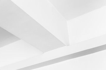 Abstract white geometric interior fragment with ceiling beams