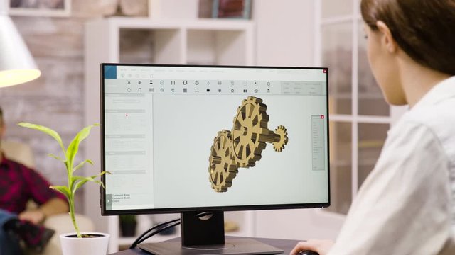 Back view of female engineer working on a mechanical concept