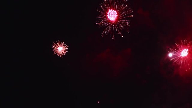 Real fireworks exploding celebration frame fill and loop seamlessly abstract blur bokeh lights in the night sky with the glowing fireworks show festival. Slow Motion 125fps to 25fps