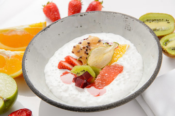 Fruit dessert in a plate on a white background