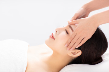 closed young woman face and head massage in spa