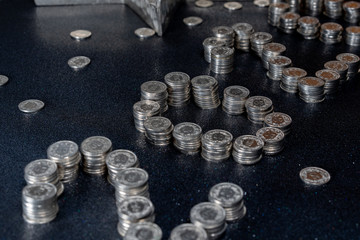 New Years 2020 graphic made from coins from Switzerland on a black shiny ground with silver star for concept. High angle view, close up.