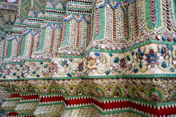Beautiful intricate details on wall of the Grand Palace ancient buddhist temple in Bangkok Thailand