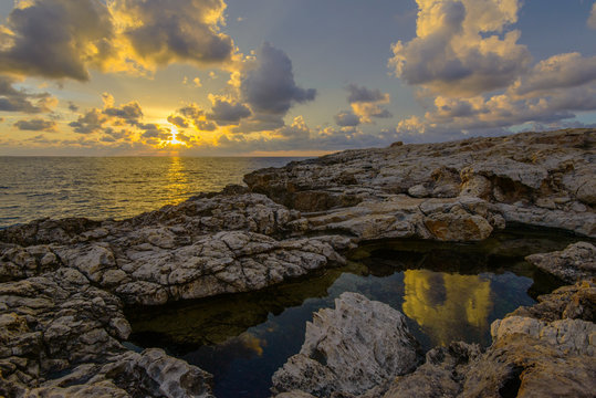 Sea and rocks against sudown scene