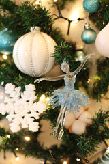 artificial Christmas tree decorated with toys in blue and white. Christmas decorations. ballerina,...