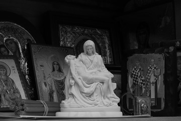 Jesus in the arms of the virgin Mary on the background of Christian icons