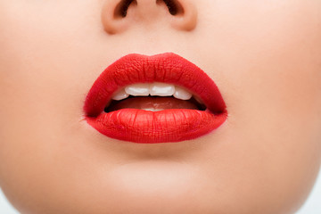 cropped view of young woman with red lipstick