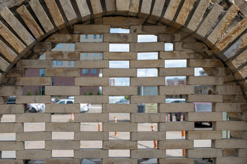 old stone arch/window with brickwork inside outdoor