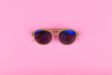 blue glasses on a pink background. Flat lay. Blue glasses on glasses. reflection. glamor.