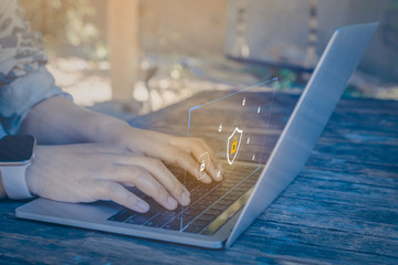Businessman using a laptop computer with technology cybersecurity and privacy concept. protection and safe data for global network security.