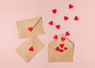 Valentines day composition made of brown envelops and red paper heart. Top view