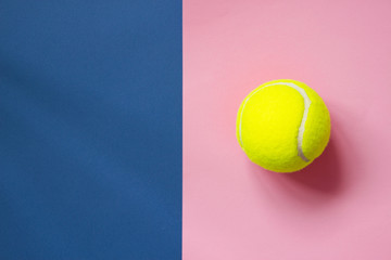 Tennis balls on blue and pink background with copy space. Color of the year 2020, horizontal format photo. Active lifestyle concept. Sports equipment, top view
