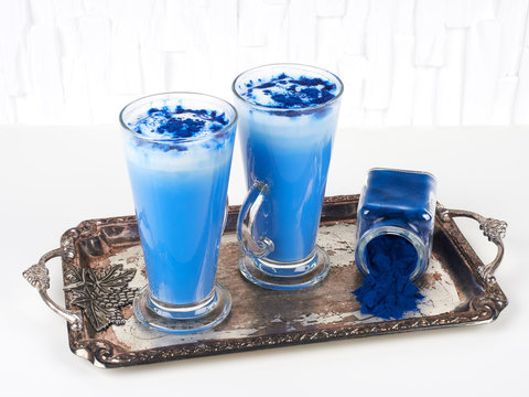 Blue spirulina latte on white background