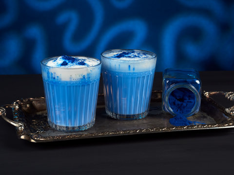 Blue spirulina latte on dark blue background
