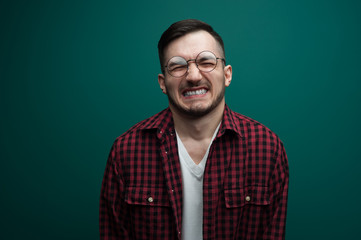Portrait of a young man writhed in pain