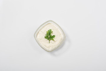 Top view of traditional greek tzatziki sauce on white background
