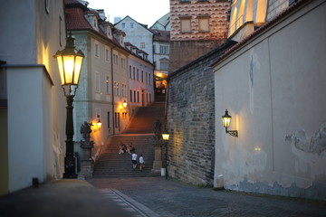 A lantern burning bright as dusk descends in Prague on a summer's evening