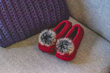 Fototapeta na wymiar Crochet slippers with fur pompom