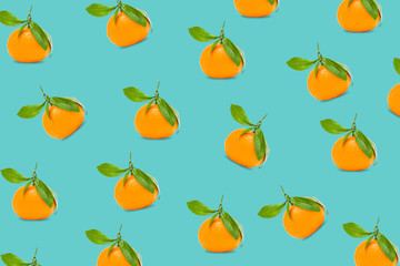 Fototapeta na wymiar Pattern food,mandarin, tangerine, clementine with green leaves, on blue background