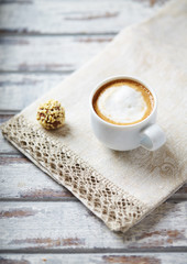 Cup of coffee with milk on bright background. 