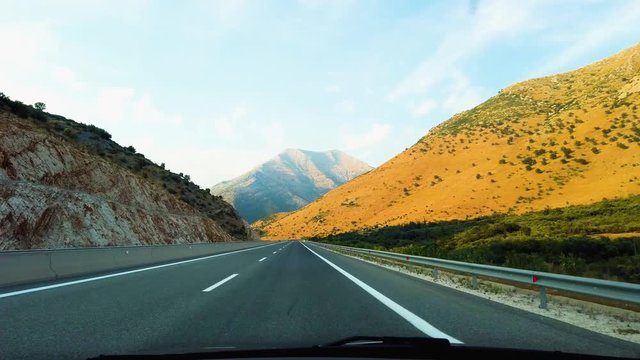 Car driving on autobahn in Greece in the afternoon straight, first person view
