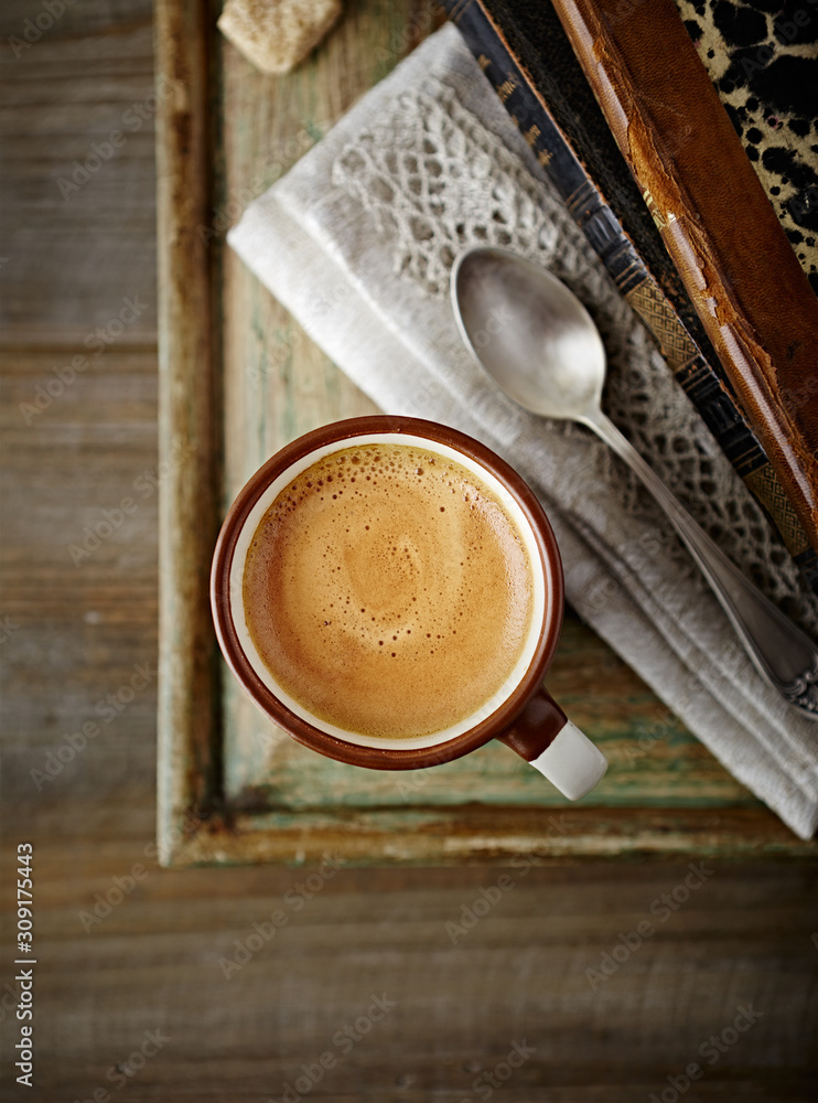 Wall mural cup of coffee on rustic wooden background. top view. close up.