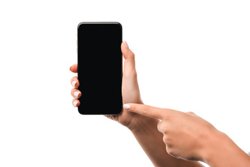 cropped view of woman pointing with finger at smartphone with blank screen isolated on white