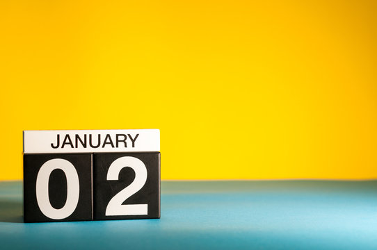 January 2nd. Day 2 of january month, calendar on yellow background. Winter time. Empty space for text