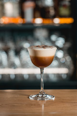Espresso vodka cocktail on a bar desk.