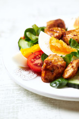 Tasty salad with eggs, cherry tomatoes and chicken briest. Close up. 