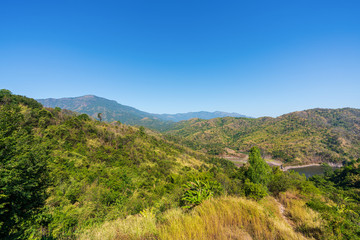 Fototapeta premium beautiful blue sky high peak mountains mist fog wildlife green forest at Khao Koh Phu Tub Berk Phetchabun Thailand guiding idea long weekend for backpacker camping campfire relaxing hiking 