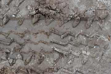 Truck tire tracks in mud and sand, texture top down close up 
