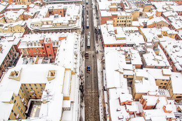 BOLOGNA, ITALY - MARCH 1, 2018.Snow Plough tractors clean the road in the center. Top view on the center of Bologna, region Emilia-Romagna.