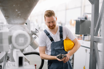 Factory worker. Man with helmet working.