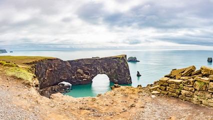 View on natural arches at Reynisfjara black beach in southern Iceland in summer