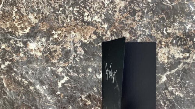 Incredible cosmic beautiful black diary on a black marble background, opens and you can make notes. Scrolling pages. Top view.