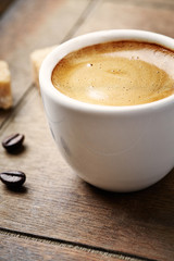 Cup of coffee on brown background. Close up. 