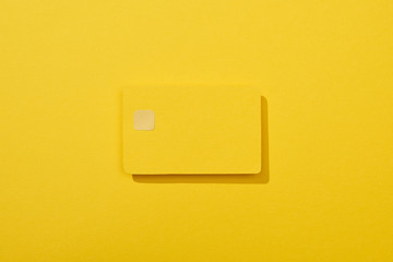 top view of colorful empty credit card on yellow background