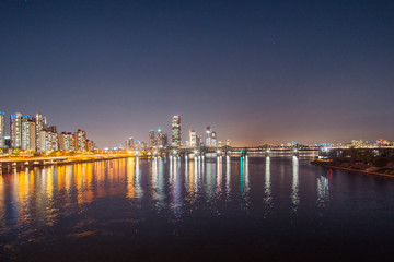 Night view of downtown from the bridge over the Han River in Seoul, Korea. 