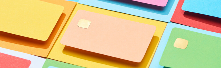 multicolored empty credit cards on colorful background, panoramic shot