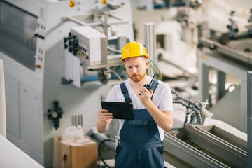 Man with helmet working in factory.
