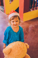 Baby in Santa Claus hat.