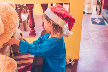 Joyful child in Santa hat.