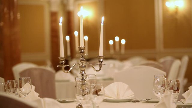 Served table with dishes and candles in a restaurant