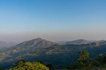 beautiful blue sky high peak mountains mist fog wildlife green forest at Khao Koh Phu Tub Berk Phetchabun Thailand guiding idea long weekend for backpacker camping campfire relaxing hiking  