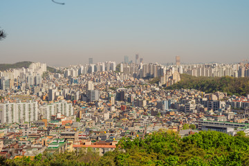 Aerial view of Seoul with buildings, houses and hill